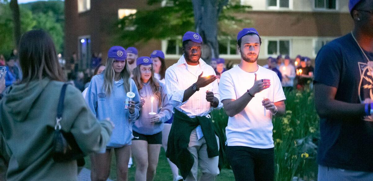 Students walk with candles during 烛光